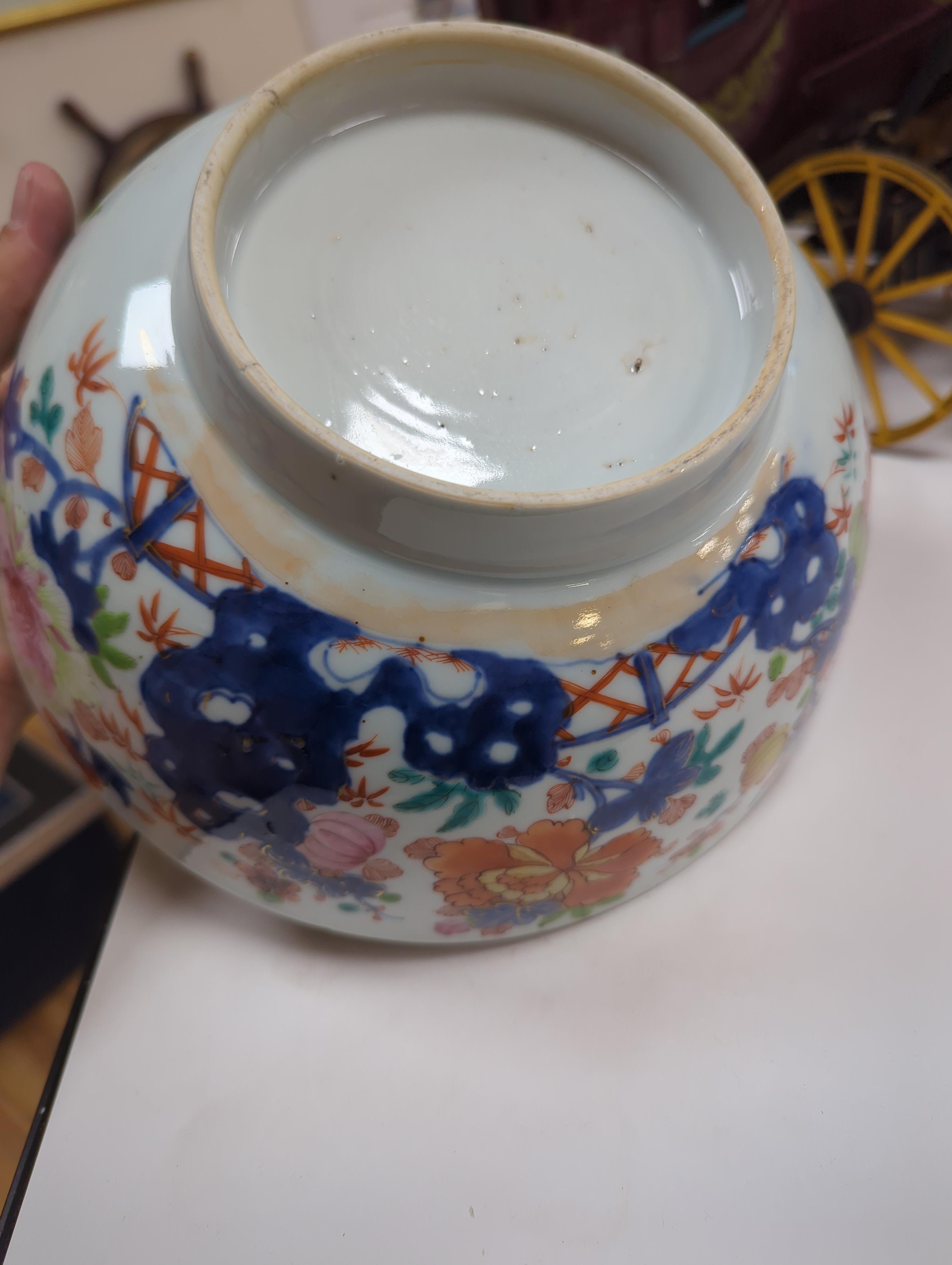 An 18th century Chinese famille rose bowl and a group of five Chinese wucai plates, each decorated with fruit, the bowl 23cm in diameter